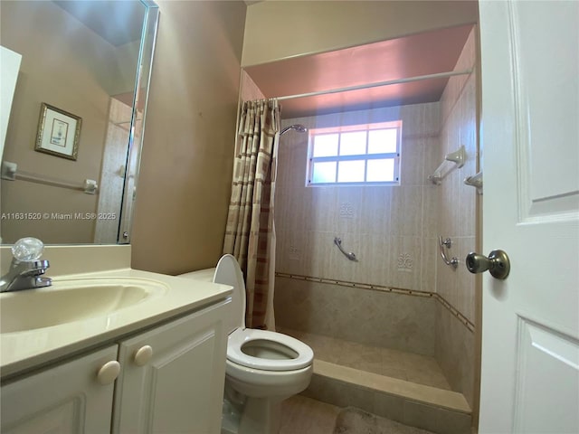 bathroom with toilet, walk in shower, and vanity