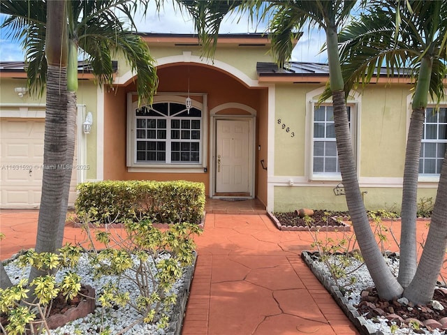 view of exterior entry with a garage