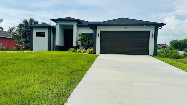 view of front of property featuring a garage and a front lawn