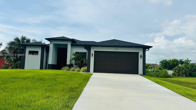 view of front of house with a garage and a front lawn