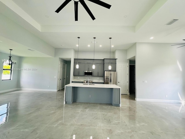 kitchen featuring appliances with stainless steel finishes, decorative light fixtures, ceiling fan, and gray cabinetry