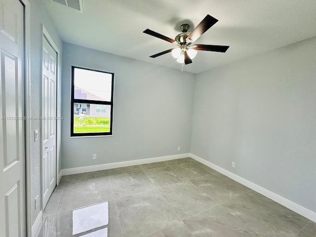 unfurnished room with ceiling fan