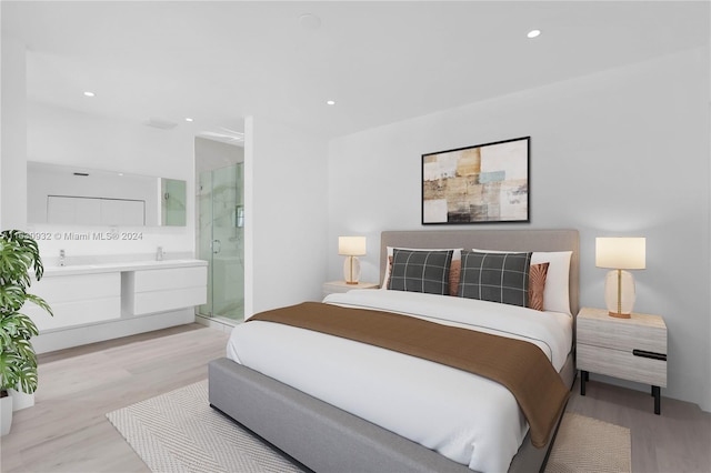 bedroom featuring light hardwood / wood-style flooring and ensuite bathroom