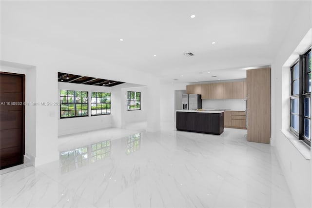 unfurnished living room with light tile patterned flooring