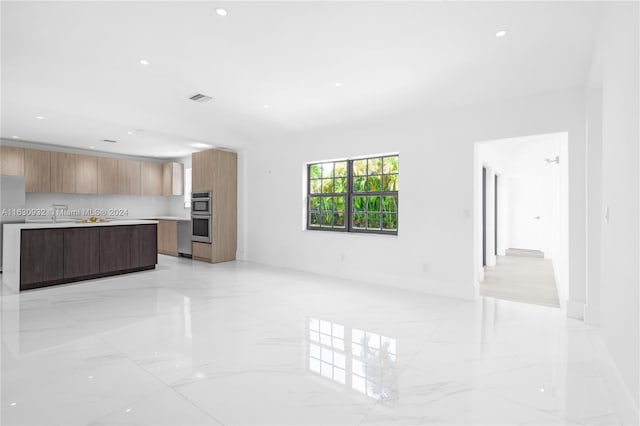 unfurnished living room featuring light tile patterned flooring