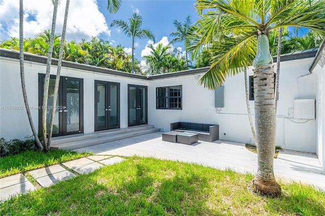 exterior space with an outdoor living space, a patio, and french doors