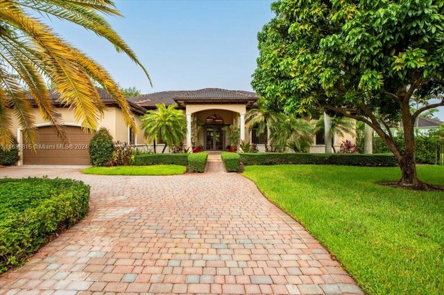 mediterranean / spanish-style house featuring a front lawn