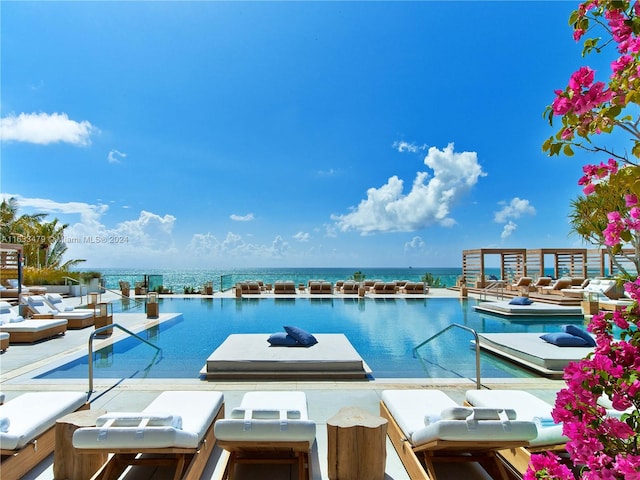 view of swimming pool with a water view