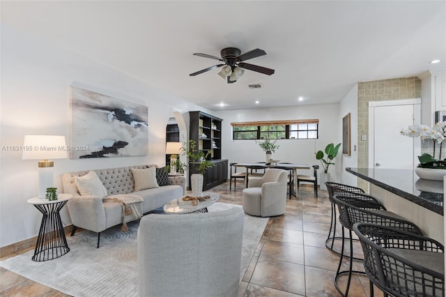 tiled living room with ceiling fan