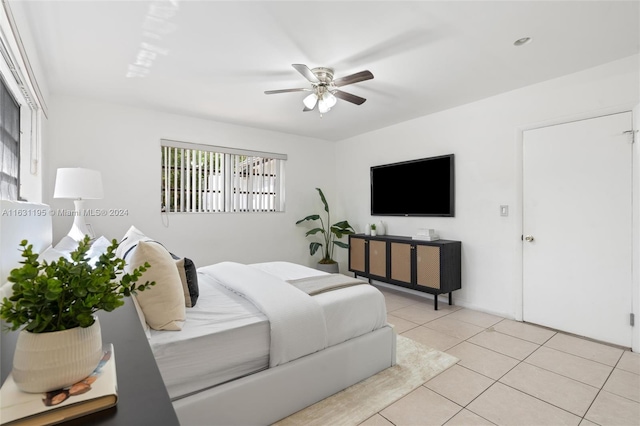 bedroom with ceiling fan and light tile patterned flooring