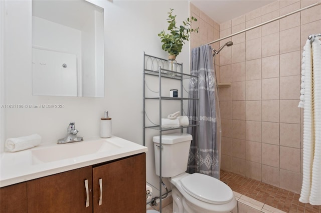 bathroom with vanity, toilet, a shower with shower curtain, and tile patterned floors