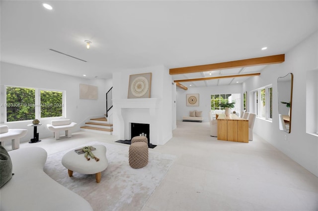 living room with plenty of natural light and beam ceiling