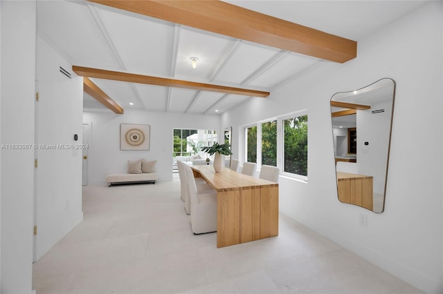 kitchen with a center island and vaulted ceiling with beams