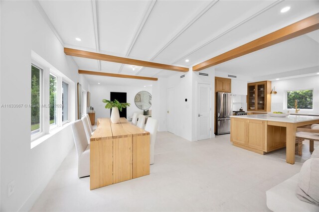 dining area featuring beamed ceiling