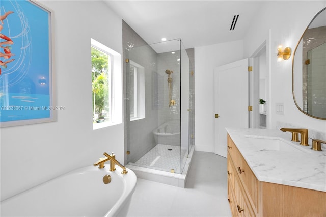 bathroom with a healthy amount of sunlight, shower with separate bathtub, and vanity