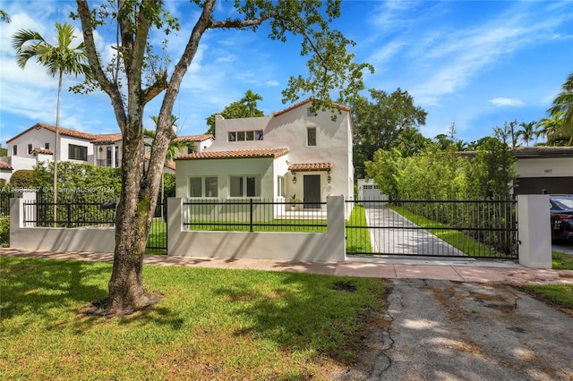 mediterranean / spanish home with a front yard