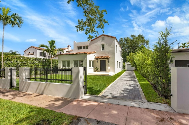 mediterranean / spanish-style home featuring a front yard