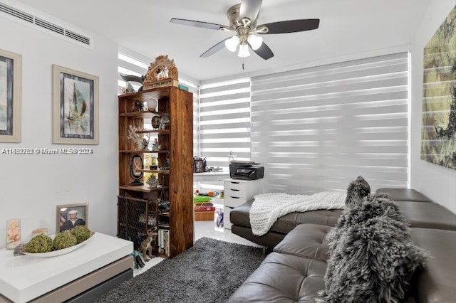 living room featuring ceiling fan and a healthy amount of sunlight