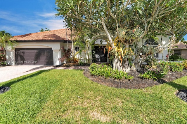 view of front of house with a garage and a front yard