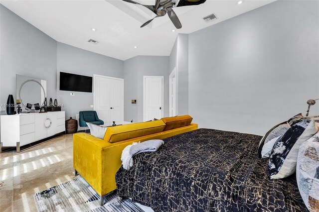 bedroom featuring ceiling fan and a towering ceiling