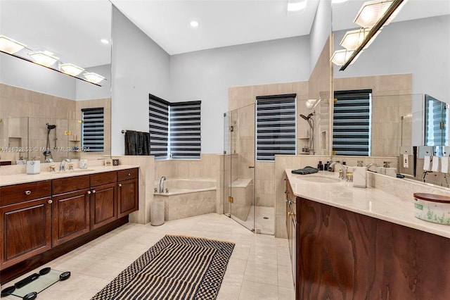 bathroom featuring tile patterned flooring, vanity, radiator, and separate shower and tub