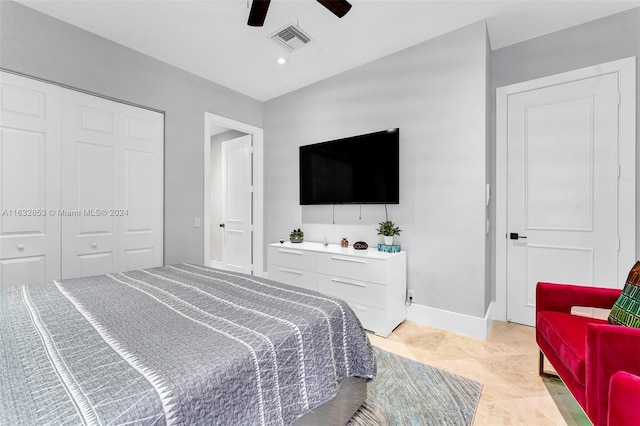 tiled bedroom featuring ceiling fan and a closet