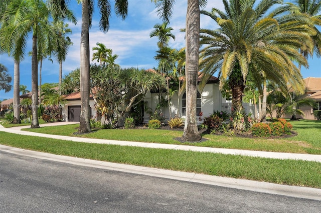 view of front of house with a garage and a front yard