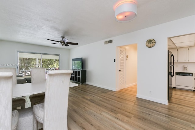 unfurnished dining area with light hardwood / wood-style flooring and ceiling fan