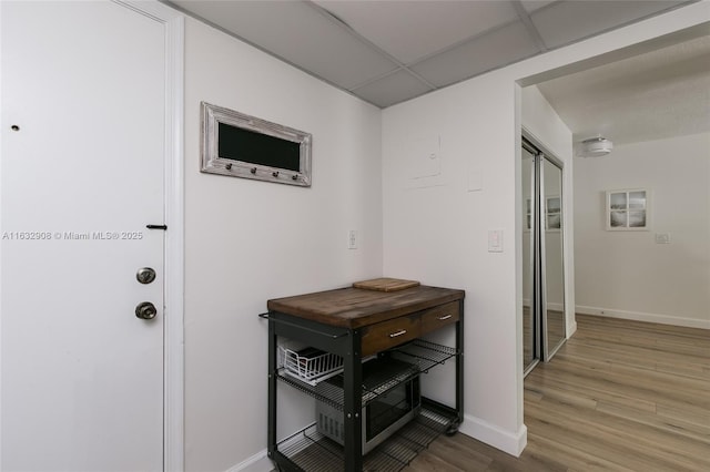 interior space with wood-type flooring and a paneled ceiling