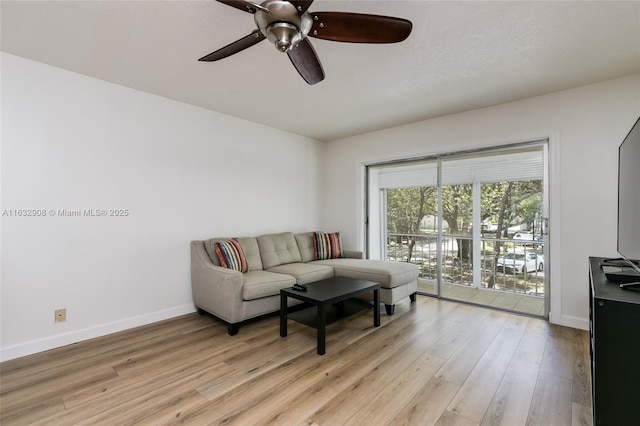 living room with light hardwood / wood-style flooring and ceiling fan