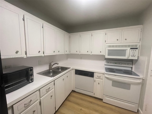 kitchen featuring white cabinets, white appliances, light hardwood / wood-style floors, and sink