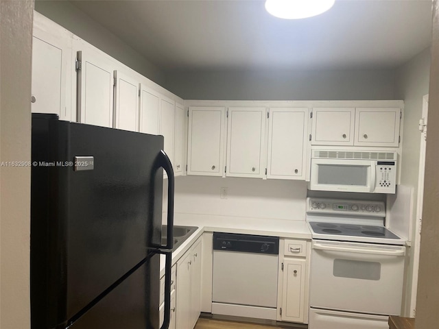 kitchen featuring white cabinets and white appliances