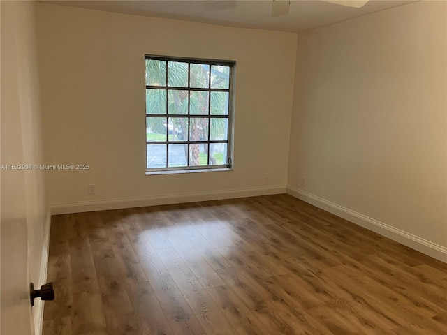 unfurnished room with hardwood / wood-style flooring and ceiling fan