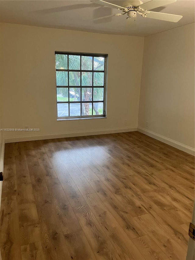 empty room featuring hardwood / wood-style floors and ceiling fan