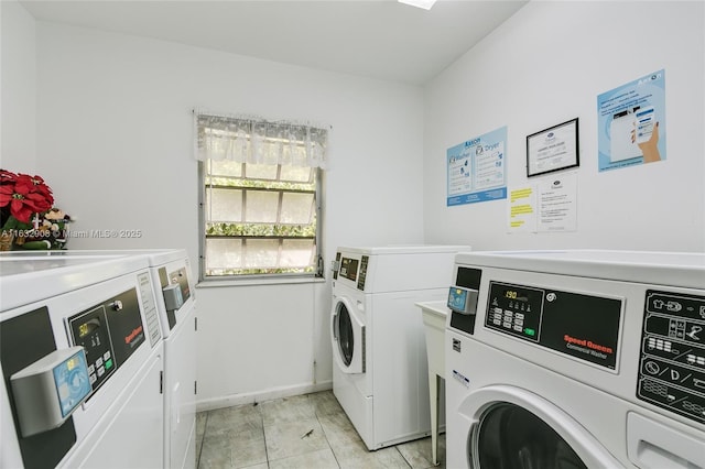 clothes washing area featuring separate washer and dryer