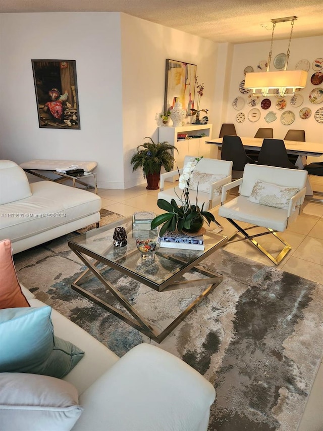 living room with a textured ceiling and light tile patterned floors