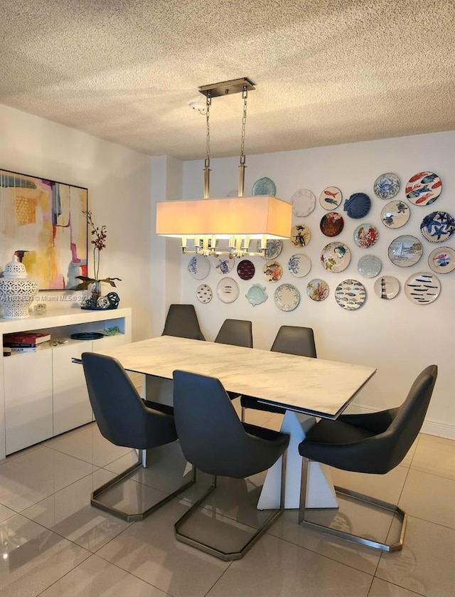 tiled dining room with a textured ceiling