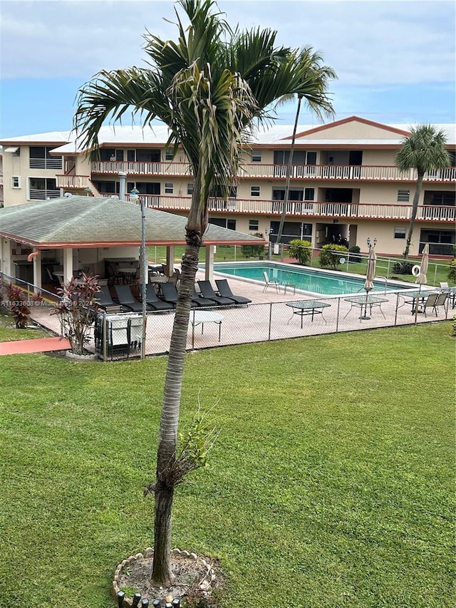 view of pool featuring a lawn