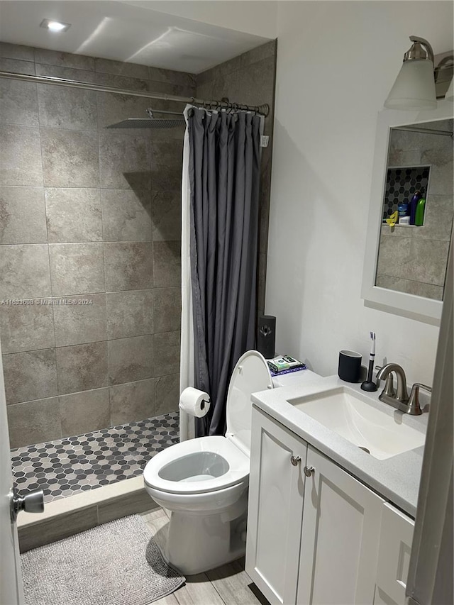 bathroom with toilet, vanity, and a shower with shower curtain