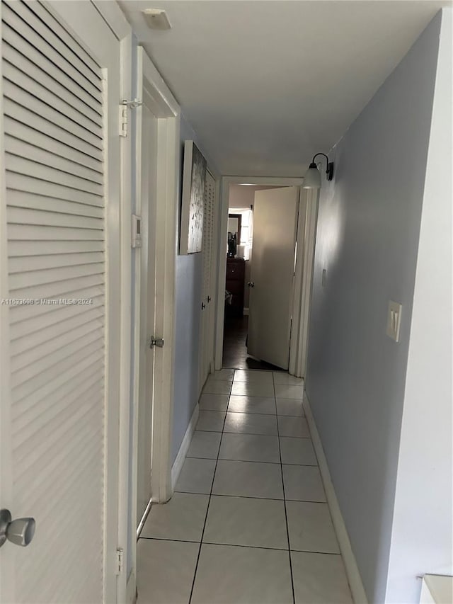 hallway featuring light tile patterned flooring