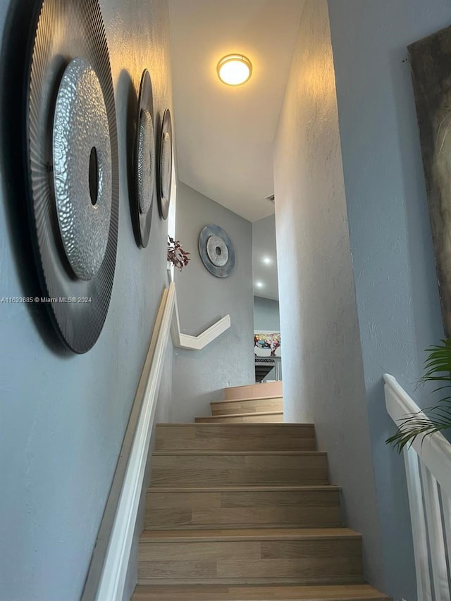 stairs featuring hardwood / wood-style floors