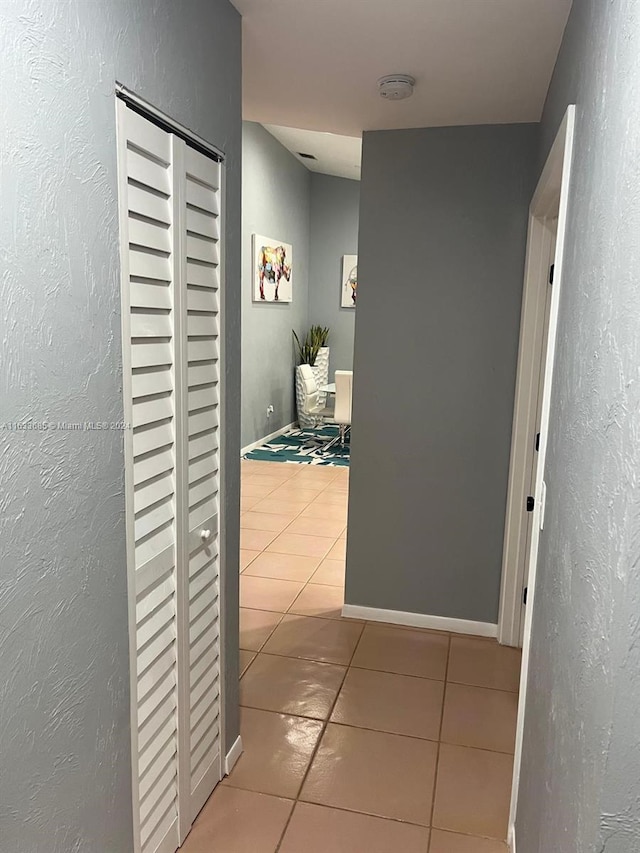 hallway featuring light tile patterned floors