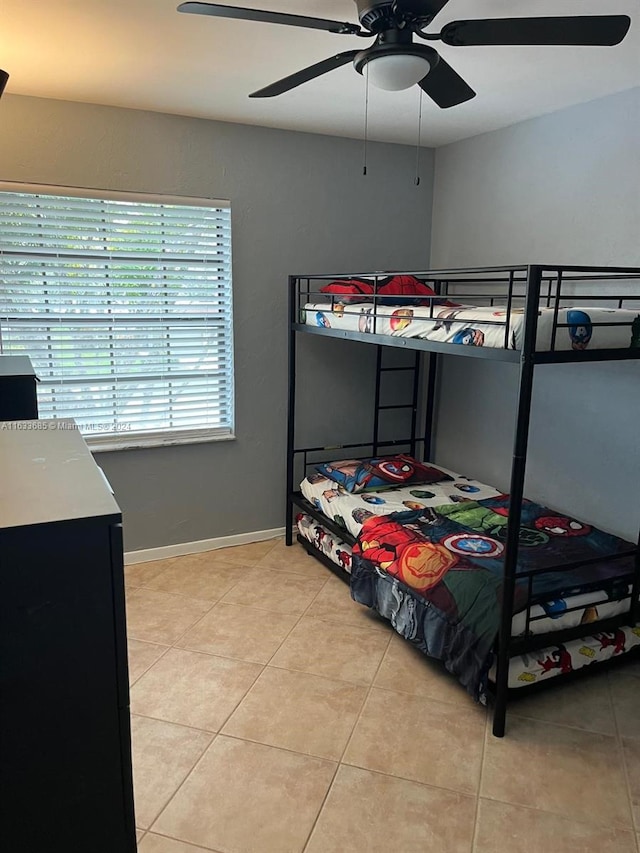 tiled bedroom with ceiling fan