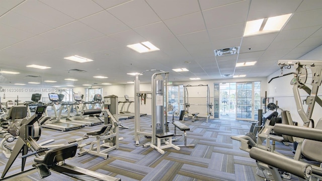 gym with a drop ceiling and carpet floors