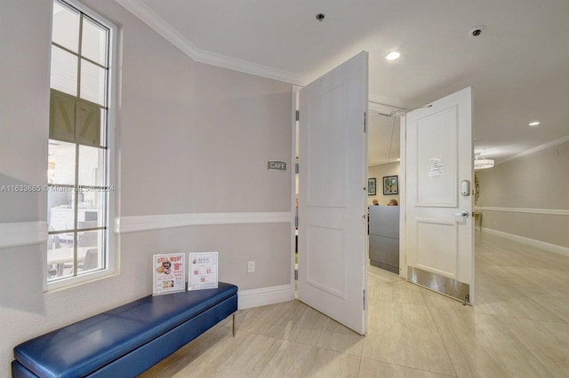 living area with light tile patterned flooring and ornamental molding