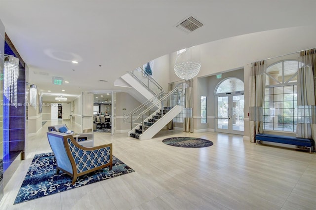 interior space with french doors and an inviting chandelier