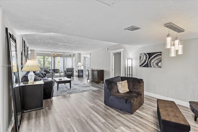 living room with a textured ceiling and hardwood / wood-style floors