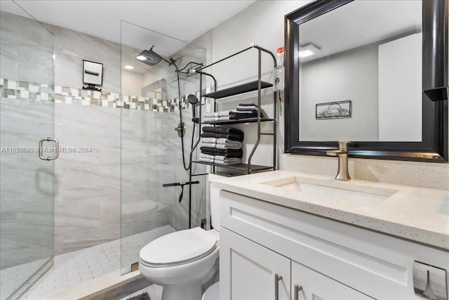 bathroom with vanity, walk in shower, and toilet