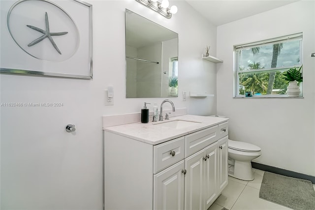 bathroom featuring tile patterned flooring, toilet, and vanity