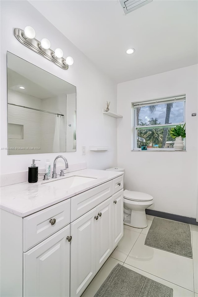 bathroom with tile patterned floors, vanity, and toilet